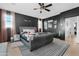 Spacious bedroom features a tufted bed, decorative lighting, and two large windows at 22501 E Indiana Ave, Queen Creek, AZ 85142