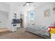 Well-lit bedroom featuring whimsical decorations, a ceiling fan, and a nearby ensuite bathroom, next to a fish tank at 22501 E Indiana Ave, Queen Creek, AZ 85142