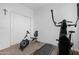 A home gym with modern exercise equipment, including an elliptical and a rowing machine, for convenient workouts at 22501 E Indiana Ave, Queen Creek, AZ 85142