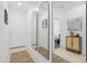 Hallway with neutral tile flooring, decorative mirrors, and modern decor at 22501 E Indiana Ave, Queen Creek, AZ 85142