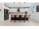 Well-lit kitchen with an eat-in island featuring modern appliances and white cabinets at 22501 E Indiana Ave, Queen Creek, AZ 85142