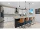 A spacious kitchen with stainless steel appliances and a large island with barstool seating at 22501 E Indiana Ave, Queen Creek, AZ 85142