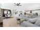 Spacious living room with a large sectional sofa, open layout, and modern decor at 22501 E Indiana Ave, Queen Creek, AZ 85142