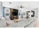 Open-concept living room features a large sectional sofa and a decorative accent wall at 22501 E Indiana Ave, Queen Creek, AZ 85142