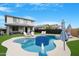 Inviting pool with basketball hoop surrounded by lush lawn and lounge chairs in backyard at 22501 E Indiana Ave, Queen Creek, AZ 85142