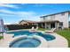 Backyard pool with lounge chairs and landscaping, creating a relaxing outdoor oasis at 22501 E Indiana Ave, Queen Creek, AZ 85142