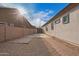 Spacious backyard with gravel landscaping, a brick pathway, and a gated entrance at 24147 N 165Th Ln, Surprise, AZ 85387