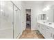 Clean bathroom with double vanity, large shower, and walk-in closet at 24147 N 165Th Ln, Surprise, AZ 85387