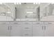 Modern bathroom with double vanity and a large mirror at 24147 N 165Th Ln, Surprise, AZ 85387
