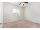 Simple bedroom with ceiling fan and window at 24147 N 165Th Ln, Surprise, AZ 85387