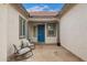 Peaceful front courtyard with rocking chairs and string lights, creating a welcoming atmosphere at 24147 N 165Th Ln, Surprise, AZ 85387