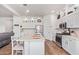 Modern kitchen with white cabinets, large island, and stainless steel appliances at 24147 N 165Th Ln, Surprise, AZ 85387