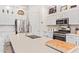 Modern kitchen with white cabinets, large island, and stainless steel appliances at 24147 N 165Th Ln, Surprise, AZ 85387
