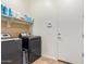 Laundry room with washer, dryer, and overhead shelving at 24147 N 165Th Ln, Surprise, AZ 85387