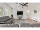 Spacious living room featuring a gray sectional sofa and a large TV at 24147 N 165Th Ln, Surprise, AZ 85387