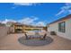 Inviting patio with fire pit, comfortable chairs, and a pergola at 24147 N 165Th Ln, Surprise, AZ 85387