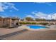 Enjoy this large pool with a wooden pergola and lounge chairs at 24147 N 165Th Ln, Surprise, AZ 85387
