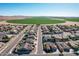 Aerial view of neighborhood with homes and a large green field at 2442 E Winged Foot Dr, Chandler, AZ 85249