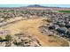 Aerial view of community with park, playground, and homes; mountains in background at 2442 E Winged Foot Dr, Chandler, AZ 85249