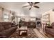 Relaxing living room with brown couches and a coffee table, hardwood floors, and lots of natural light at 2442 E Winged Foot Dr, Chandler, AZ 85249
