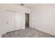 Comfortable bedroom with neutral carpet and sliding closet doors at 24914 N 173Rd Ln, Surprise, AZ 85387