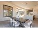 Modern dining area with dark wood table and access to backyard at 25572 N 119Th St, Scottsdale, AZ 85255