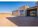 Back of house showing tan siding, large windows and a patio at 25572 N 119Th St, Scottsdale, AZ 85255