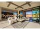 Open living room with kitchen views, high ceilings, and large sliding glass doors at 25572 N 119Th St, Scottsdale, AZ 85255