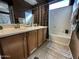 Bathroom featuring a double sink vanity, framed mirror and a shower tub combination at 2573 W Lewis And Clark Trl, Anthem, AZ 85086