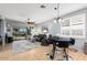 Bright and airy living room with a ceiling fan, gray toned walls, neutral tile floors, and natural light at 2573 W Lewis And Clark Trl, Anthem, AZ 85086