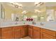 Bright bathroom with corner sinks and large mirror at 28175 N 123Rd Ln, Peoria, AZ 85383