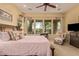 Spacious bedroom with large windows and soft pink bedding at 28175 N 123Rd Ln, Peoria, AZ 85383