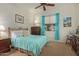 Charming bedroom with light teal bedding and a ceiling fan at 28175 N 123Rd Ln, Peoria, AZ 85383