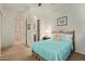 Guest bedroom with teal bedding and access to a bathroom at 28175 N 123Rd Ln, Peoria, AZ 85383
