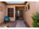 Inviting front entry with a covered patio and brick flooring at 28175 N 123Rd Ln, Peoria, AZ 85383