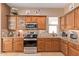 Well-equipped kitchen featuring wood cabinets and granite countertops at 28175 N 123Rd Ln, Peoria, AZ 85383