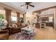 Open concept kitchen and living area with island and breakfast bar at 28175 N 123Rd Ln, Peoria, AZ 85383