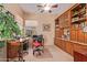 Home office with built-in shelving and a comfortable chair at 28175 N 123Rd Ln, Peoria, AZ 85383