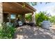Covered patio with seating area, grill, and lush landscaping at 28175 N 123Rd Ln, Peoria, AZ 85383