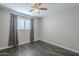 Bedroom with ceiling fan and window with gray curtains at 2914 E Cactus Rd, Phoenix, AZ 85032