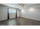 Bright bedroom with ceiling fan, dark laminate flooring and window coverings at 2914 E Cactus Rd, Phoenix, AZ 85032