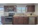Modern kitchen featuring stainless steel appliances and dark wood cabinets at 2914 E Cactus Rd, Phoenix, AZ 85032