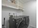 Laundry room with LG washer and dryer and overhead shelving at 2914 E Cactus Rd, Phoenix, AZ 85032