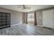 Living room with gray vinyl flooring, ceiling fan, and burgundy curtains at 2914 E Cactus Rd, Phoenix, AZ 85032
