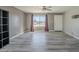 Bright living room with gray vinyl flooring, large window and ceiling fan at 2914 E Cactus Rd, Phoenix, AZ 85032
