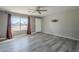 Living room with gray vinyl flooring, ceiling fan, and burgundy curtains at 2914 E Cactus Rd, Phoenix, AZ 85032