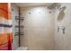 Shower with tiled walls, built-in shelving and curtain at 2914 E Cactus Rd, Phoenix, AZ 85032