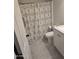 Updated bathroom with white vanity and patterned shower curtain at 3810 N Maryvale Pkwy # 1093, Phoenix, AZ 85031