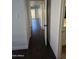 Hallway with dark hardwood floors and access to other rooms at 3810 N Maryvale Pkwy # 1093, Phoenix, AZ 85031