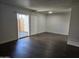 Living room with dark hardwood floors and patio access at 3810 N Maryvale Pkwy # 1093, Phoenix, AZ 85031